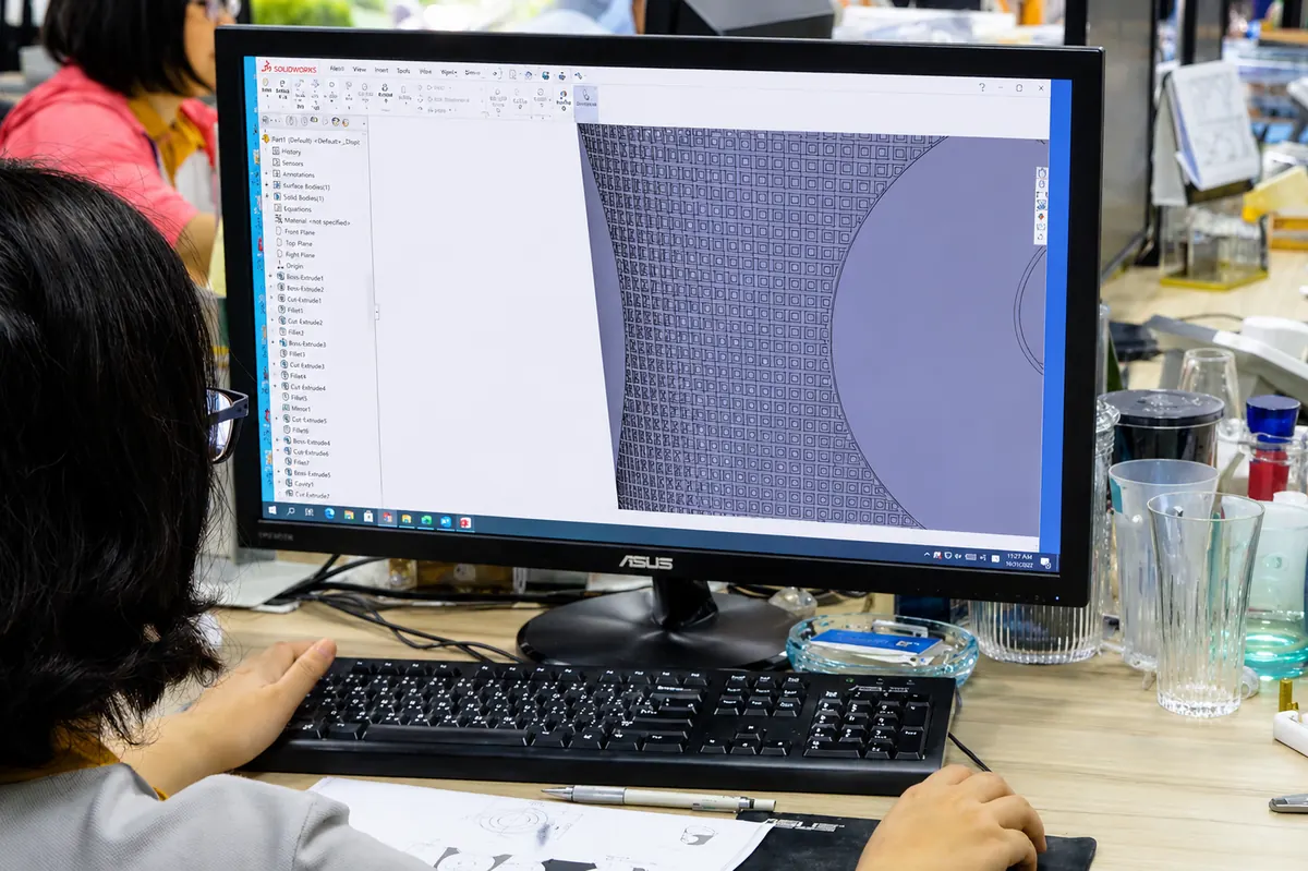 Mold designer working on injection mold CAD and cooling-channel layout